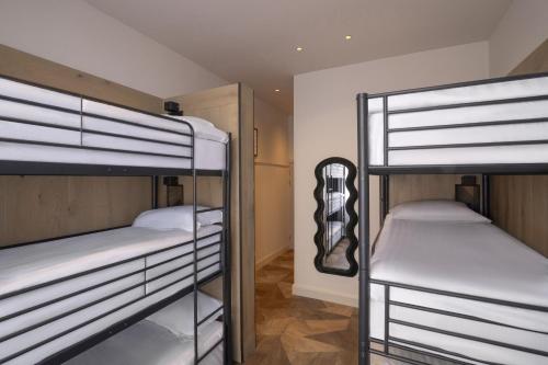 a room with three bunk beds in a room at Limerick City Hotel in Limerick