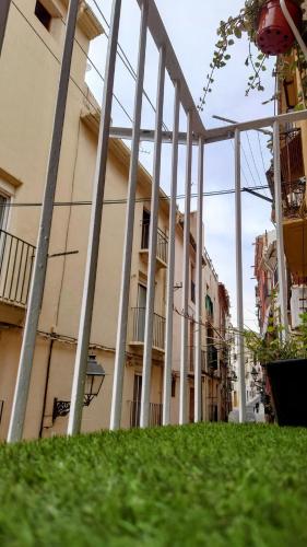 a building with columns and grass in front of it at Entre el mar y la montaña in Jijona