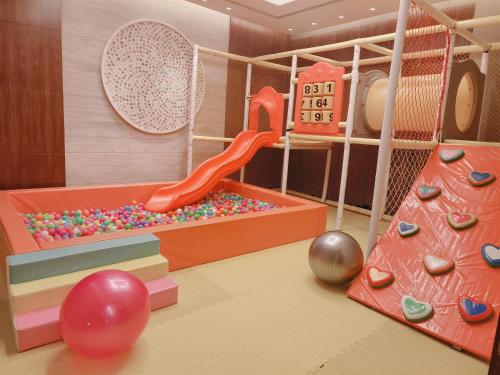 a childrens play room with a slide and balls at Yanqi Hotel, Managed by Kempinski in Huairou