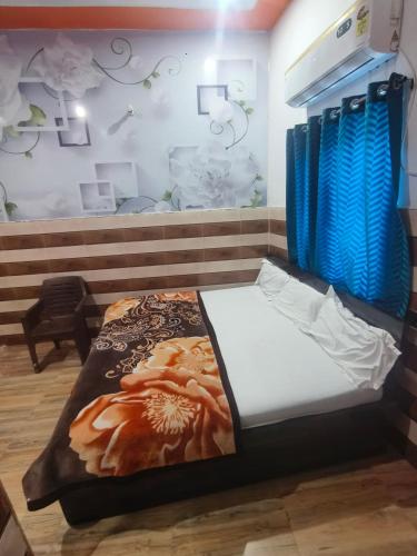 a bed in a room with blue curtains at KD Dham family Stay near by Prem Mandir in Vrindāvan