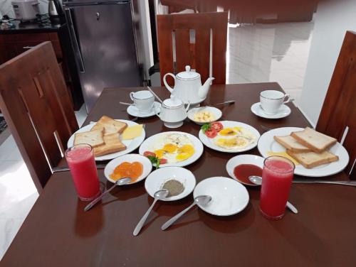 a wooden table with eggs and bread on it at Serene Villa in Hikkaduwa