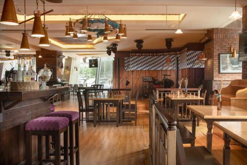 a restaurant with wooden floors and tables and chairs at Kempinski Hotel Taiyuan in Taiyuan