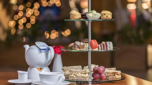 a three tiered display of pastries and desserts on a table at Kempinski Hotel Taiyuan in Taiyuan