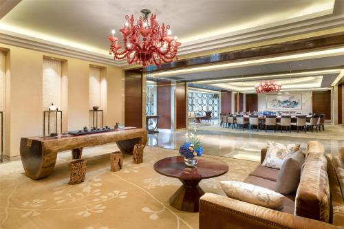 a lobby with a pool table and a dining room at Kempinski Hotel Taiyuan in Taiyuan