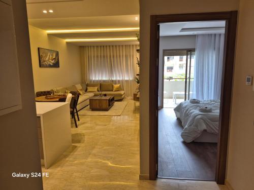 a living room with a couch and a bed in a room at aeroperla 15 aéroport casa blanca in Nouaseur