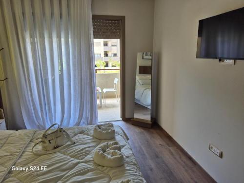 a bedroom with a bed with white shoes on it at aeroperla 15 aéroport casa blanca in Nouaseur