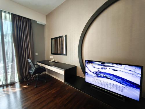 a living room with a large mirror on the wall at The Shore Residences by Amanjiwa in Melaka