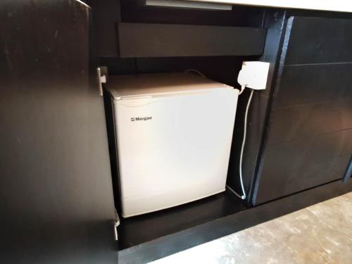 a small white box in the corner of a refrigerator at The Shore Residences by Amanjiwa in Melaka