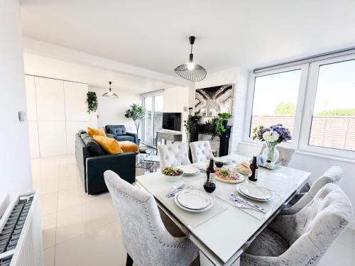 a dining room and living room with a table and chairs at Luxury Nest 10 Guests Free Parking Middlesbrough in South Bank