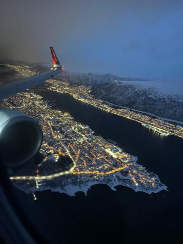 an aerial view of a city from an airplane at Stille leilighet med topp beliggenhet i Tromsø sentrum in Tromsø