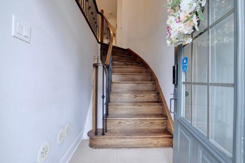 a wooden staircase with a metal handrail in a house at Heart of Port Credit, Lakefront, Dining & Shopping in Mississauga