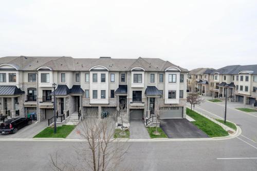 a group of houses in a city with a street at Heart of Port Credit, Lakefront, Dining & Shopping in Mississauga