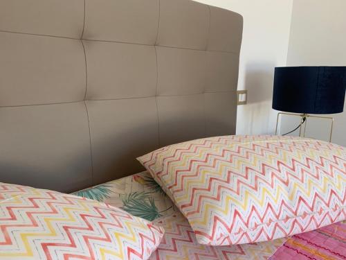 a bedroom with a bed with a pillow and a lamp at Cento Giorni B&B Costa Paestum in Capaccio-Paestum