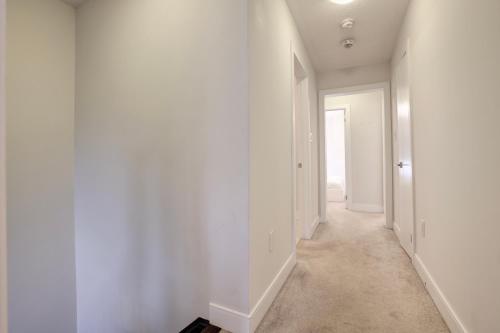 an empty hallway with white walls and a door at Heart of Port Credit, Lakefront, Dining & Shopping in Mississauga