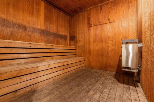 an empty wooden sauna with a trash can at Mammoth Getaway - Chic Condo in Mammoth Lakes