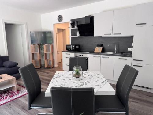 a kitchen with a table and chairs in a room at Sorinas Home WB16 Top 11 in Wagersbach