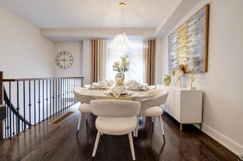 a dining room with a white table and chairs at Heart of Port Credit, Lakefront, Dining & Shopping in Mississauga