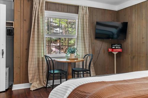 a bedroom with a table and a tv on a wall at 2- Chattanooga Suite in Lookout Mountain