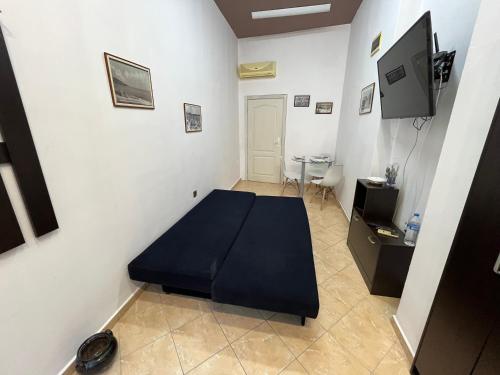 a room with a bed and a table in it at Varna Cathedral Apartments in Varna City