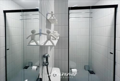 two people are standing in a shower in a bathroom at Simple Smart Residence in Tambaú