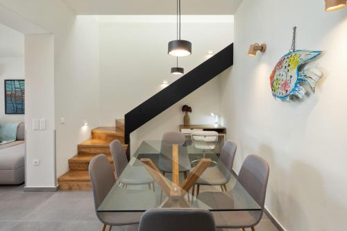 a dining room with a glass table and chairs at AGGELLE Villa in Potamós