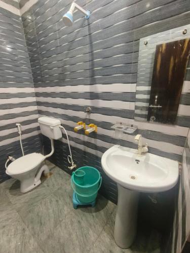 a bathroom with a sink and a toilet at KD Dham family Stay near by Prem Mandir in Vrindāvan