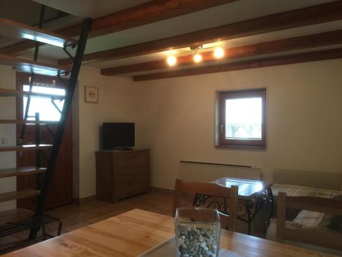 a living room with a table and a television at Apartments Vila Cvetka Bled in Bled