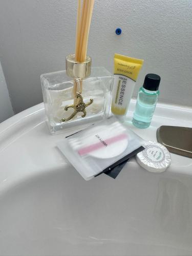 a bathroom counter with a sink with a container and cosmetics at Heart of Port Credit, Lakefront, Dining & Shopping in Mississauga