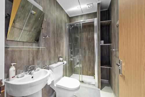 a bathroom with a toilet and a sink and a shower at Invicta Hotel Plymouth in Plymouth
