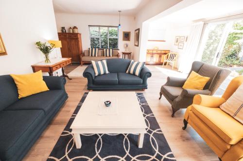 a living room with couches and a coffee table at Birdsong in Hermanus