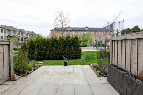 a walkway in a yard with houses in the background at Heart of Port Credit, Lakefront, Dining & Shopping in Mississauga