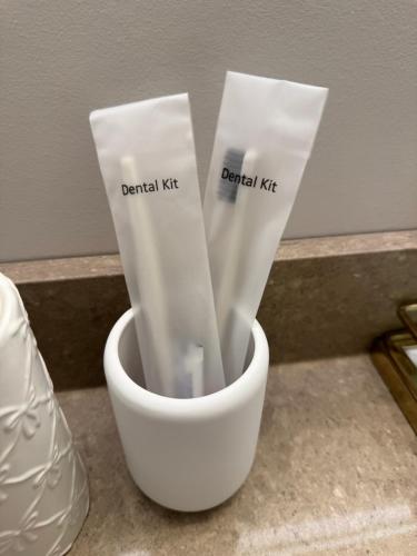 two white toothbrushes in a white cup on a counter at Heart of Port Credit, Lakefront, Dining & Shopping in Mississauga