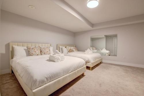 a bedroom with two beds and a large mirror at Heart of Port Credit, Lakefront, Dining & Shopping in Mississauga