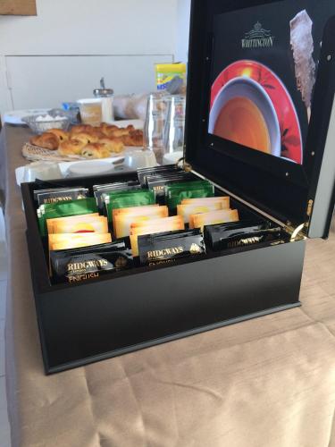 a black box filled with cheese and a plate of donuts at Les Chambres d'Hôtes de la Mer in Merlimont
