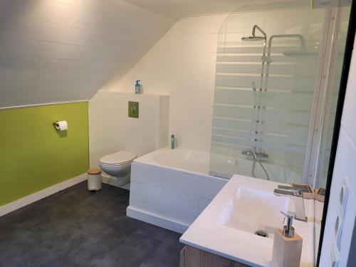 a bathroom with a tub and a toilet and a sink at Le studio in Spa