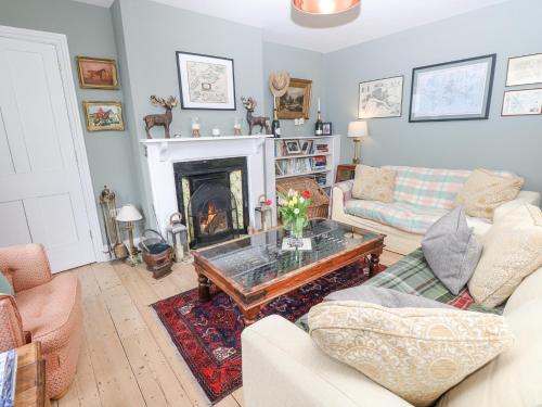a living room with a couch and a fireplace at Milston in Ventnor