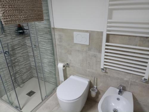 a bathroom with a shower and a toilet and a sink at Bb7 house in Trieste
