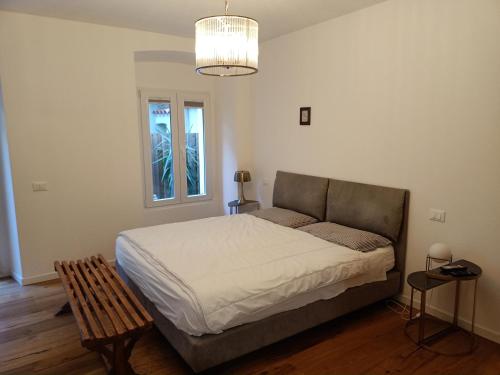 a bedroom with a bed and a chandelier at Bb7 house in Trieste