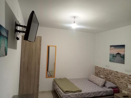 a living room with a couch and a flat screen tv at Alojamientos Playa Centro Corralejo 1 in Corralejo