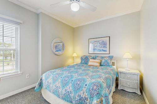 a bedroom with a bed and a ceiling fan at Beach Peace - DIBC 206B in Dauphin Island