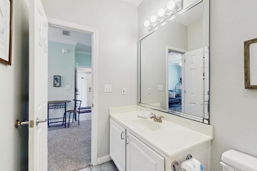 a bathroom with a sink and a mirror at Beach Peace - DIBC 206B in Dauphin Island