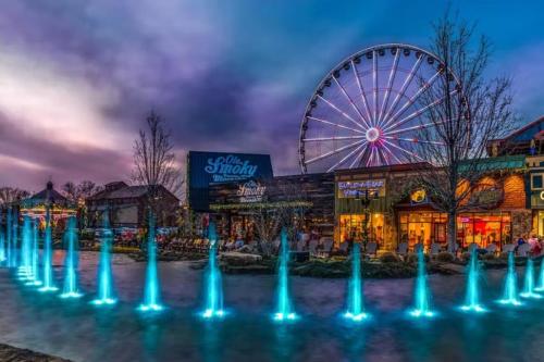 a ferris wheel in front of a amusement park at My Tennessee A-Frame by Avada Properties in Sevierville