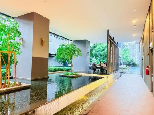 a room with a pond in the middle of a building at Star Residence KLCC By Cozy in Kuala Lumpur