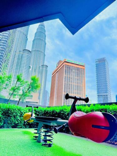 a skateboard parked in a park in a city at Star Residence KLCC By Cozy in Kuala Lumpur