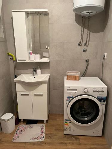 a small bathroom with a washing machine and a sink at Sava Lux in Brčko