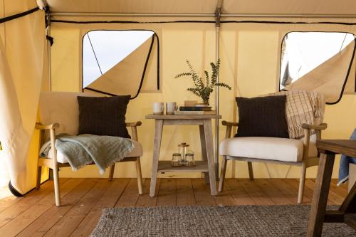 a living room with two chairs and a table at Collective Retreats Governors Island in New York