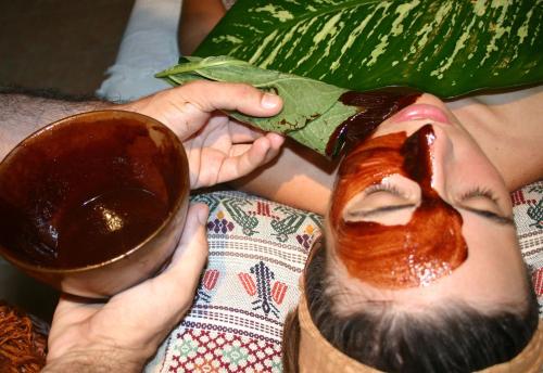 a person cutting a mask with a pair of scissors at Hacienda Chichen Resort and Yaxkin Spa in Chichén-Itzá
