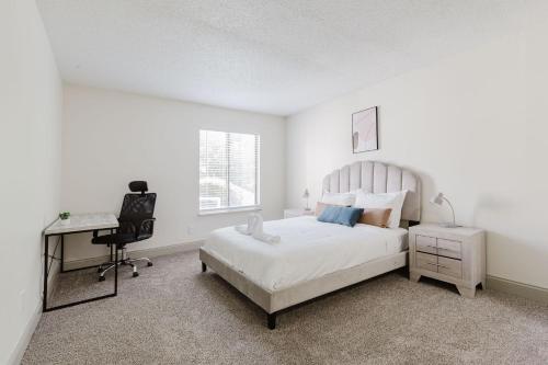 a bedroom with a bed and a desk and a chair at Rosehill Pointe 185 I Spacious 1 Bed 1 Bath in Lenexa