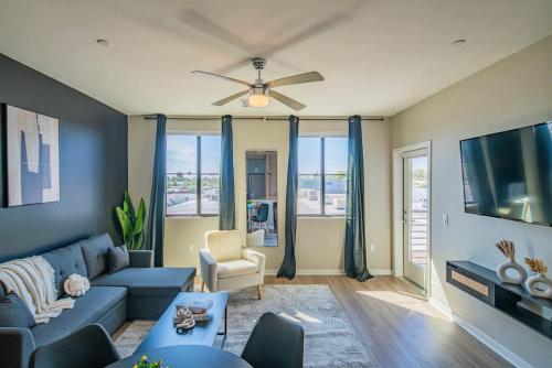 a living room with a blue couch and a tv at Convenient 1BR Uptown Biltmore Gym Pool Parking in Phoenix