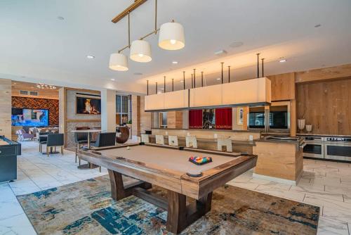 a large kitchen with a pool table in a room at Convenient 1BR Uptown Biltmore Gym Pool Parking in Phoenix